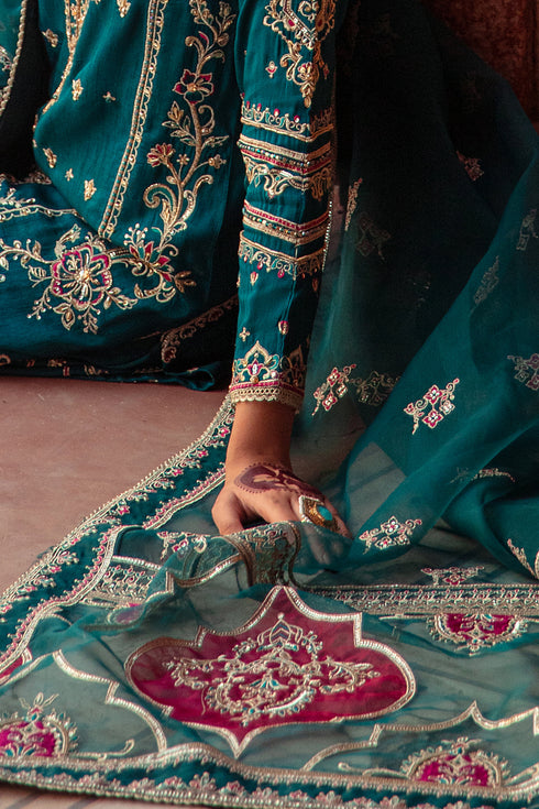 Model in full Zamurd 3PC set: zinc organza shirt, raw‑silk sharara & embellished dupatta styled for festive elegance.
